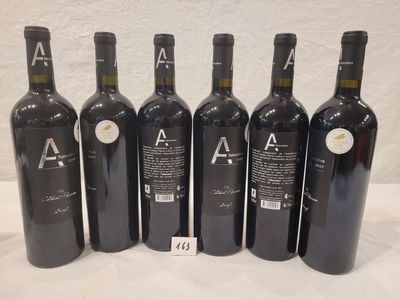 six bottles of wine are lined up in a row on a table