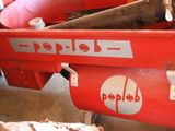 a red dump truck with a red dumpster in the back