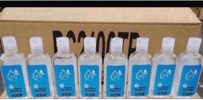 six bottles of water sitting in front of a cardboard box
