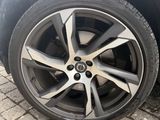 the wheel of a car with a flat tire on a cobblestone road