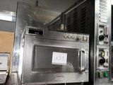 a silver microwave sitting on top of a metal counter