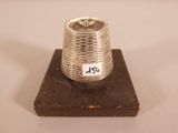 a silver ring sitting on top of a piece of wood
