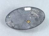a silver plate with a gold square on it