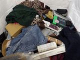 a pile of clothes and other items in a suitcase