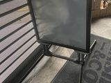 a television on a stand in front of a window