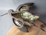 a sculpture of a bird that is on a table