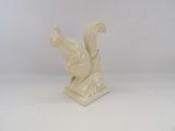 statue of a squirrel on a pedestal with a white background