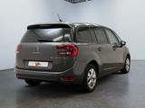 the back of a grey citrole is parked in a room