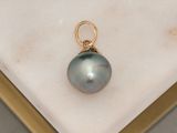 a black tahiti pearl pendant on a gold plated base