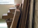 a pile of cardboard in a room with a window