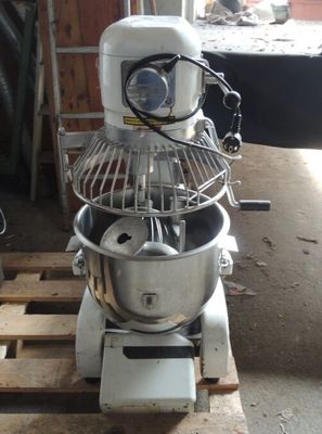 a mixer that is sitting on a pallet in a garage