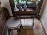 a small table with two stools in front of a window