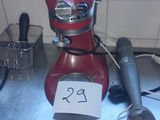 a red mixer sitting on a counter with a price tag on it