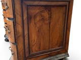 an image of a wooden chest of drawers on casteors