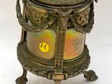 a small brass box with a lid on a stand