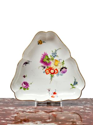 a white plate with flowers on it sitting on a table