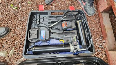 a tool kit in a case on the ground next to a pair of shoes
