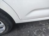 a close up of a white car with water droplets on it