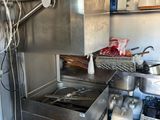 a kitchen with a sink, stove, and other items in it