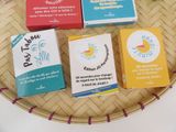 four boxes of soap sitting on top of a wicker basket