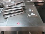several pans are stacked on top of a stove in a kitchen