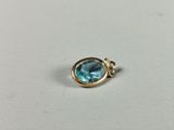 a close up of a ring with a blue topaz stone