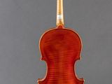 a violin on a stand on a gray background