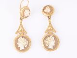 an image of a pair of earrings with a woman ' s profile
