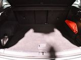 a trunk of a car with an orange bag in the trunk