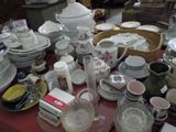 a table with a lot of dishes and cups on it