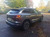 the rear end of a silver suv parked in a parking lot
