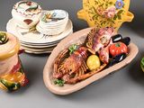 a lot of dishes and vases that are sitting on a table