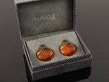 pair of orange glass cufflinks in a gift box on a black surface