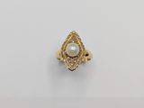 a gold ring with a pearl and diamonds