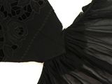 the back of a black dress with black lace on it