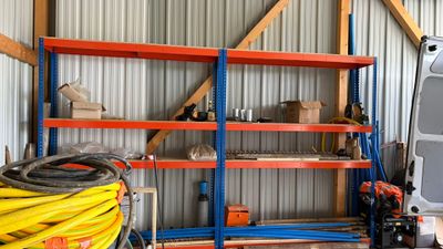 a truck that is parked in a garage next to a shelf