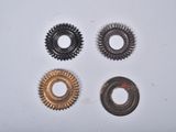 four different types of gears are shown on a white surface