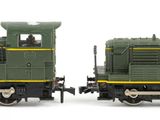 two toy trains sitting side by side on a white surface