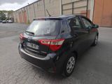 the back end of a black toyota yaris parked in a parking lot