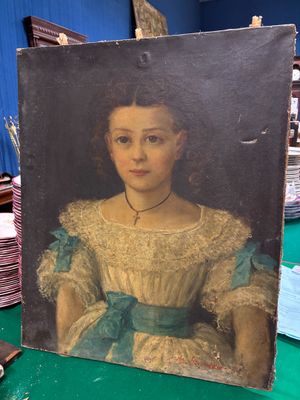 une photo d'un tableau représentant une femme, posé sur une table