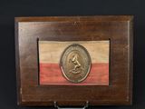 a wooden box with a gold medal on top of it