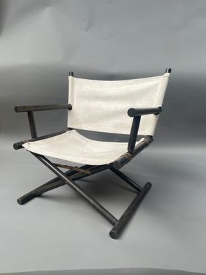 an image of a white and black folding chair on a grey background