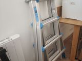 a ladder that is leaning against a wall in a room