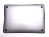 the back of a silver laptop computer sitting on top of a white surface