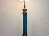a blue lamp that is on a white table