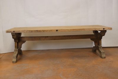 a wooden bench sitting on the floor in a room