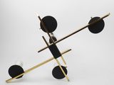 an image of a black and gold sculpture on a white surface