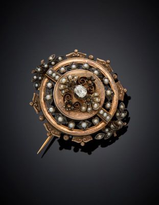 a close up of a broochle with pearls on a black background