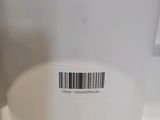 a white toilet with a bar code on the lid