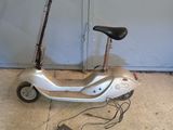 a scooter that is parked in front of a garage door